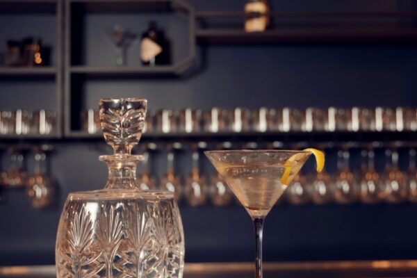 glassware on bar with lemon twist